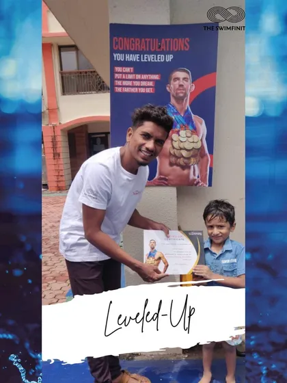 A proud moment for one of our youngest swimmers as he receives his level-up certificate from his coach. Well done!