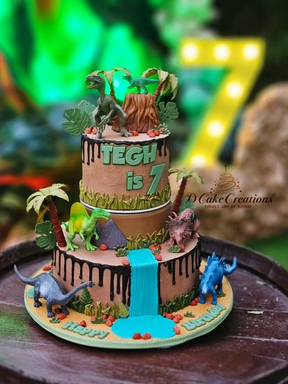 Another angle of the dino-mite cake, with a large "7" marquee light in the background, showing how the cake fits into the party's theme.