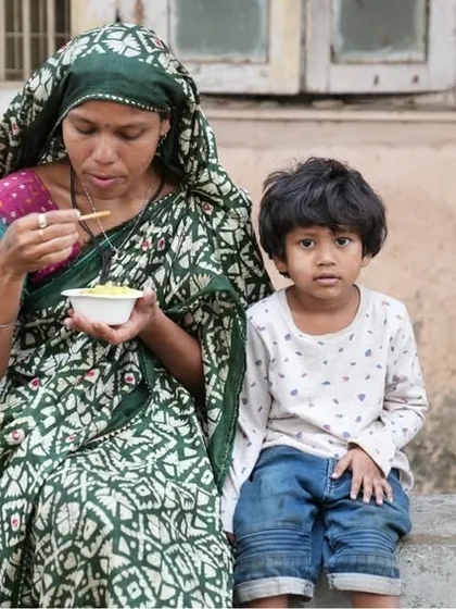 A mother and her child sharing a meal. These quiet moments of dignity and care are at the heart of our Annam Brahma mission.