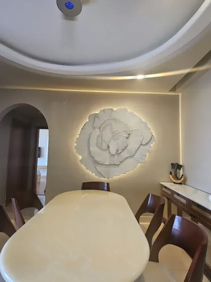 This large scale 3D floral installation became the heart of our client's dining room. Weighing over 40 kgs, this textured wall art piece shows how we can transform a simple wall into a dramatic and elegant statement, complete with custom backlighting.