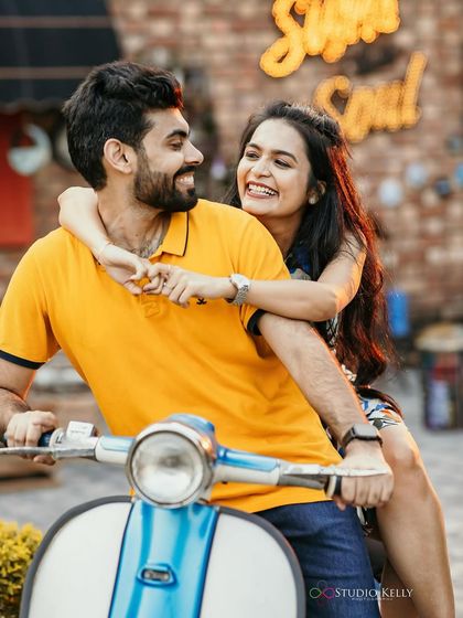 A close-up on the scooter, highlighting her bright smile and the fresh, natural makeup look.