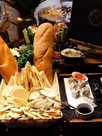 A wide view of our appetizer station, featuring breads, crackers, and sushi, ready for guests.