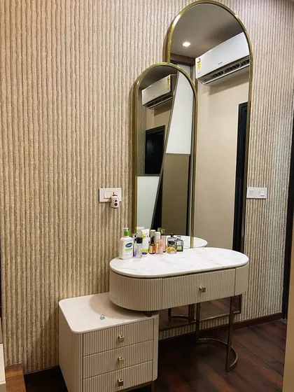 Perfection in a custom-made dresser and mirror set for a client. The design features a fluted texture, a marble top, and elegant arched mirrors, creating a glamorous and functional vanity space.