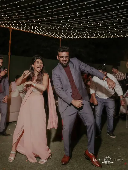 The couple having a blast on the dance floor during their engagement party. Their energy is infectious.