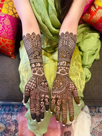 A classic bridal design with initials hidden within the pattern, featuring elephants, kalash, and jaali work.