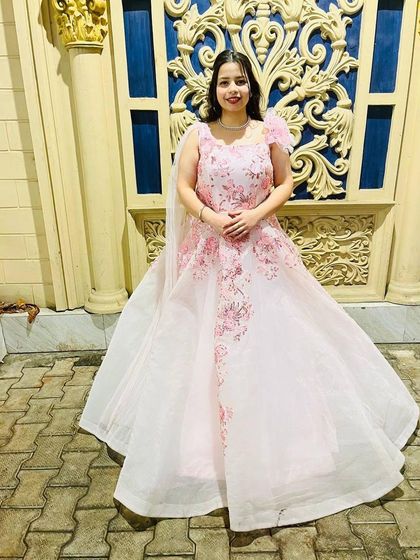 This full-length view shows the beautiful silhouette of the white and pink ball gown. It’s a popular rental choice for engagements and pre-wedding shoots.