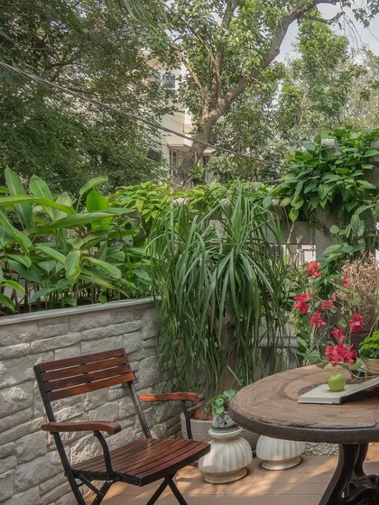 I believe in creating a strong connection to nature. This outdoor patio is designed as a lush, green extension of the living room. Simple wooden furniture and curated planters create a tranquil space to unwind and enjoy the fresh air.