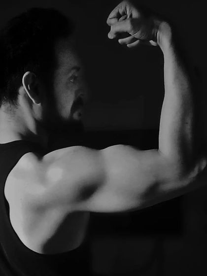 This artistic shot highlights the bicep peak. Building impressive arms is a common goal, and I provide the techniques to develop both size and shape.