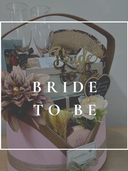 A complete "Bride-to-be" hamper in a stylish pink hat box. It includes everything from a personalized photo frame and champagne glasses to a cute slate board for messages and other pamper goodies.