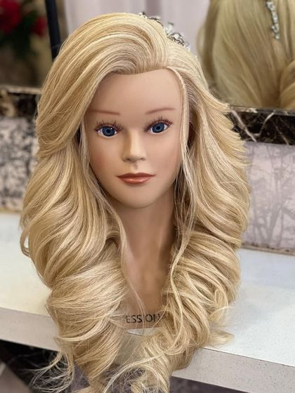 The final look of the curly hairstyle with a front variation on a mannequin.