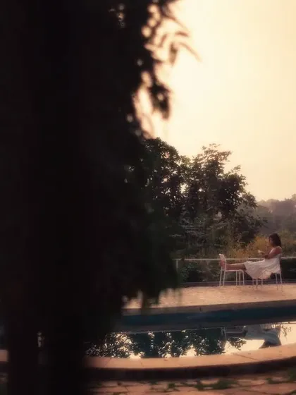 This shot feels like a distant memory, framed by the leaves of a tree. I often use this technique of shooting through objects to create a dreamy, film-like aesthetic that adds a layer of intimacy and nostalgia to the scene.