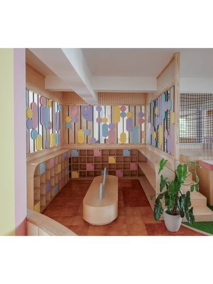 The storage and activity area at Nivriti playschool. I used low, accessible cubbies and colorful, abstract shapes on the windows to create a stimulating and organized environment for the toddlers.