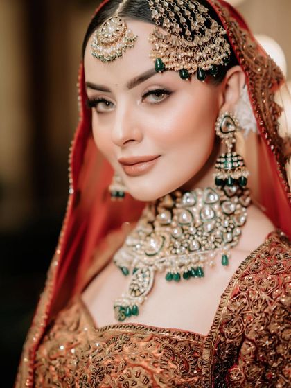 A close-up of a bride with flawless makeup, wearing our heavy kundan passa and choker set.