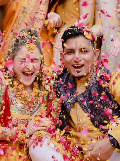 The Haldi ceremony is pure joy, and this shot is all about that infectious energy. Capturing the genuine laughter and fun as the couple gets showered with flower petals is what makes these moments unforgettable.