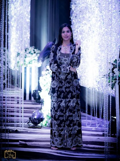 A full-length shot of the co-ord set against a glamorous, lit-up backdrop.