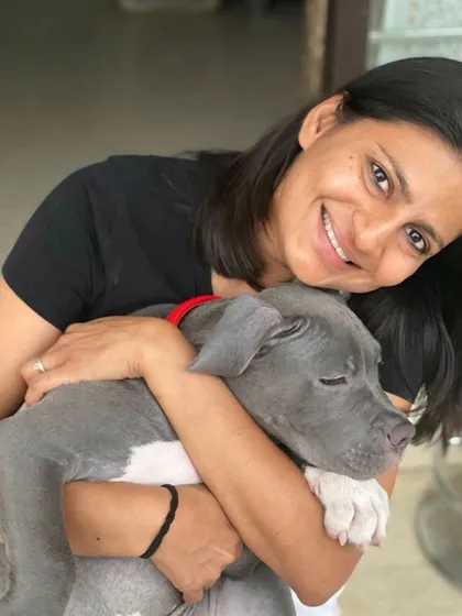 A warm embrace for a young Brutus from our founder, Vizal. We've been his second home since he was a pup, building a bond of trust and affection over the years.