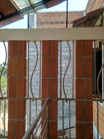 A security grille with an undulating metal design, adding an artistic touch to a functional element.