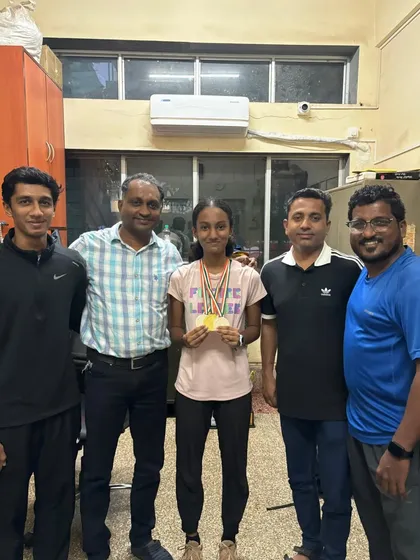 Our athlete Navya with her coaches, celebrating her gold and silver medals in 100m, 200m, and long jump events.
