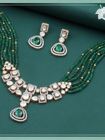 Our Green Grace necklace, where strands of emerald beads meet a magnificent Polki and diamond centerpiece. This design marries traditional materials with a contemporary layout for a truly grand effect.