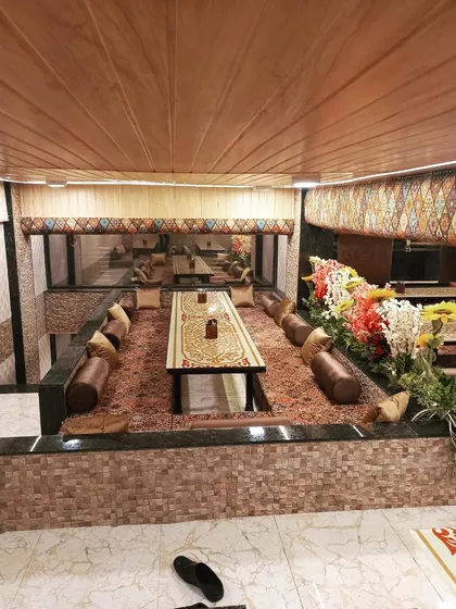 A view of my signature Dastarkhwan seating arrangement, with low tables, plush carpets, and comfortable cushions. This setup is designed to bring families and friends together for a traditional, shared meal.
