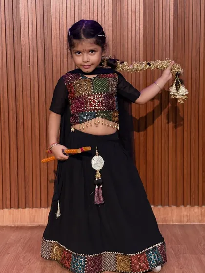 This student showcases her beautiful multi-colored choli and traditional jewelry. We celebrate the rich details of Indian culture through costume and dance.