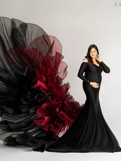 A dramatic studio shot with a black and red flowing gown, creating a sense of movement and high fashion.