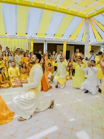 The groom's proposal during the Haldi ceremony, surrounded by cheering friends and family. A truly memorable moment.