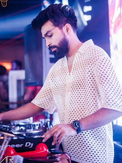 A color version of me mixing at The Fixx Bar, showing off my unique perforated shirt.