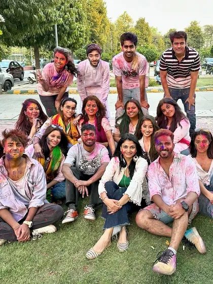 The entire crew covered in colors after a successful and fun-filled Holi video shoot.