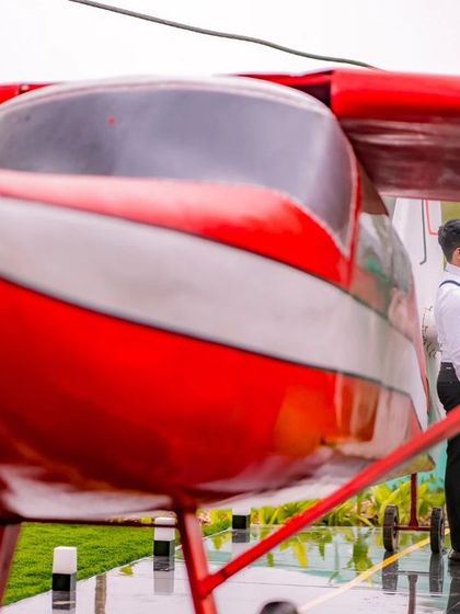 A maternity portrait with the red airplane, symbolizing the new journey the couple is embarking on.