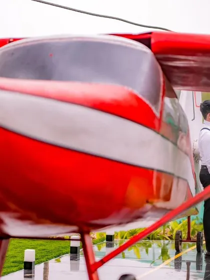 A maternity portrait with the red airplane, symbolizing the new journey the couple is embarking on.