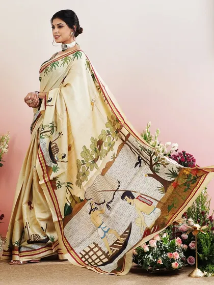 An ivory saree with a charming print depicting life in the backwaters of Kerala.