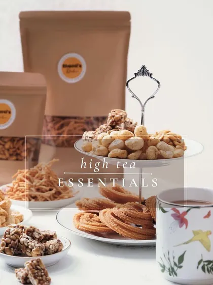 My high tea essentials are perfect for an elegant afternoon. This tiered stand features a delightful assortment of my handmade snacks, including savoury murukku and sweet peanut chikki, paired perfectly with a cup of tea.