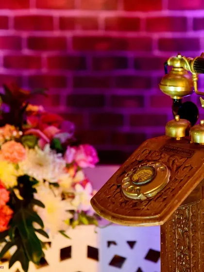 A touch of nostalgia. This vintage rotary phone is a charming prop that adds character and a sense of history to the decor.