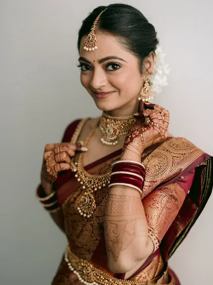 A portrait of grace. Aditi, in her stunning Kanjivaram saree, embodies the timeless charm of a bride preparing for her Telugu wedding. I focus on these details, from the intricate jewelry to the delicate mehendi.