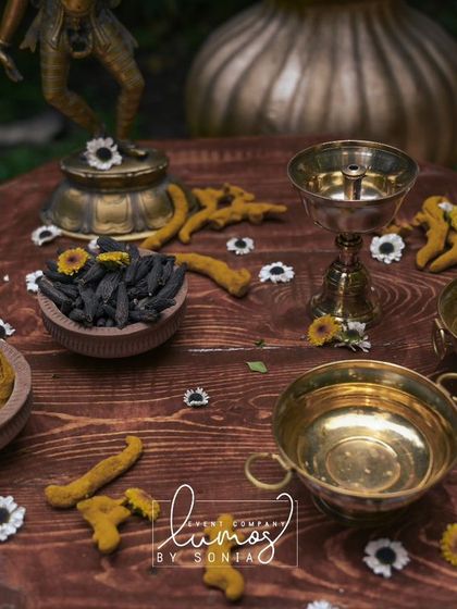 A close-up of the Haldi ceremony ingredients, including turmeric and other spices, arranged on a rustic wooden table.