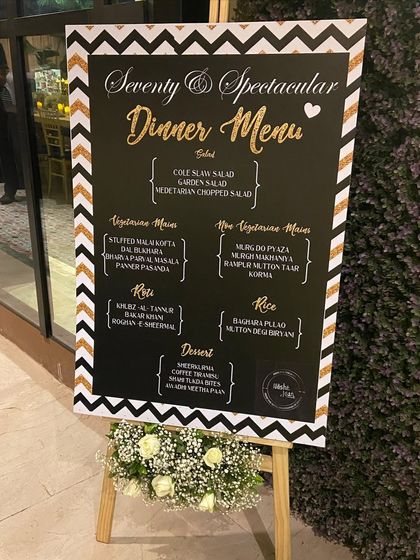 The full dinner menu, displayed elegantly on a decorated easel. This ensures guests know what culinary delights to expect while adding to the sophisticated ambiance of the event.