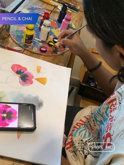 A student paints a vibrant pink flower, using a photo reference to capture its delicate details. Through art, you don't just create; you grow in confidence and self-connection.