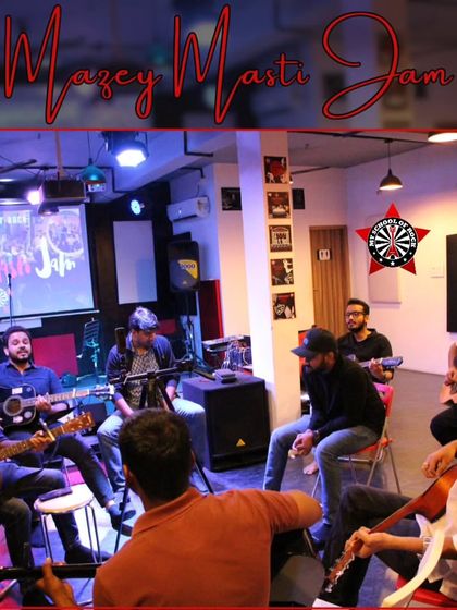 A wide shot of a jam session in progress, showing the classic circle of musicians playing together that defines our community events.