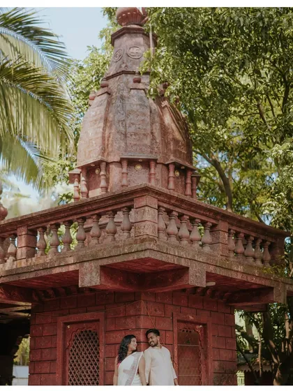A low-angle shot that emphasizes the grandeur of the temple and the couple's place within it. A beautiful composition from their traditional pre-wedding shoot.