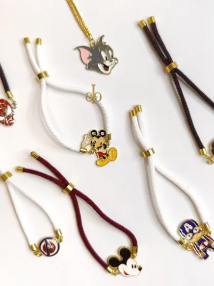 A collection of our cartoon and superhero-themed Rakhis for kids, featuring characters like Tom, Mickey Mouse, Captain America, and Spider-Man.