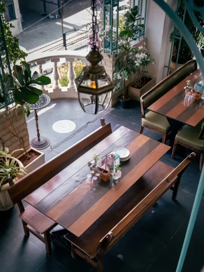 Sunlight finds its way into every corner. This view shows one of our semi-private spaces, perfect for a sunlit brunch, an intimate gathering, or a quiet moment away from the crowd.
