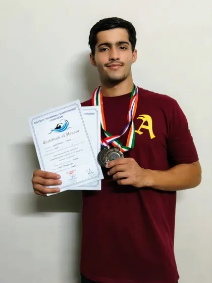 Deepanshu Hans showing off his 5 medals, including a gold, from a district meet. His performance was marked by significant personal best swims.