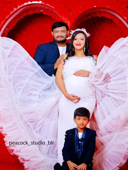 Celebrate your journey to motherhood with a family maternity shoot. I provide beautiful gowns and props, like these angel wings, to create a magical and memorable portrait for your growing family in my themed studio.
