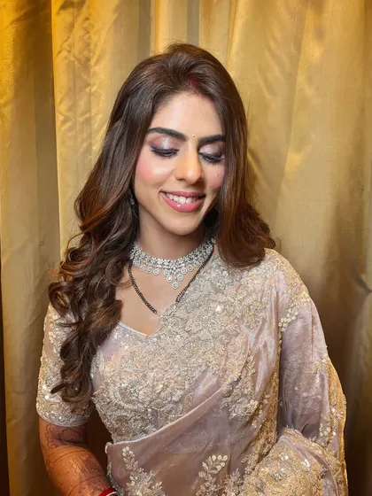 Reception ready and radiating elegance. This soft, shimmery eye makeup and flowing hair create a look that is both graceful and glamorous.
