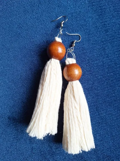 I also make these simple tassel earrings, combining soft cotton fiber with a polished wooden bead. They have a natural, earthy feel and are wonderfully light to wear.