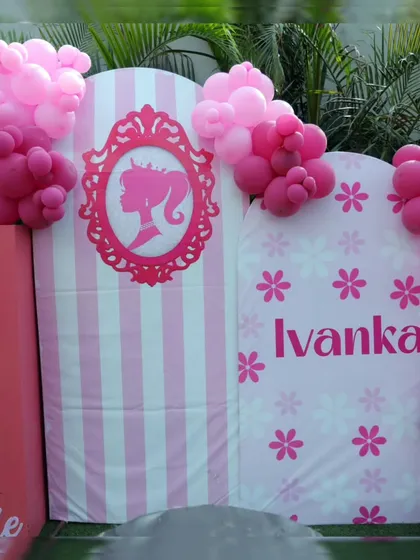 A closer look at the personalized Barbie backdrop, featuring a classic silhouette and the birthday girl's name. The life-sized Barbie box is a favorite spot for photos.