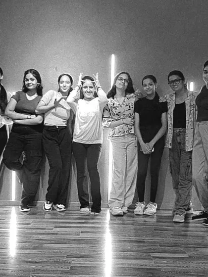 A black and white shot of our students, capturing a moment of friendship and fun. It's more than a class; it's a community.