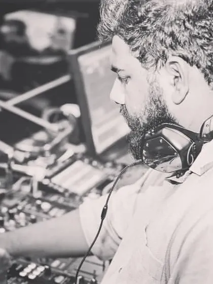A black and white shot showing the focus it takes to manage the music and the energy of the room.