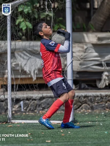 Our U11 goalkeeper confidently collecting the ball during a Thane Youth League match.